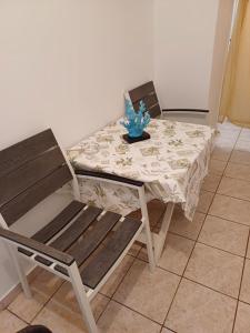 a dining room table with a table and a chair at Villa Vasiliki in Amorgos +2 photos