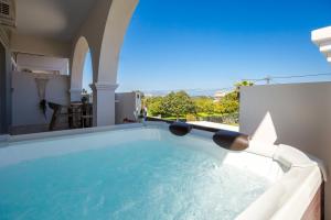 a large swimming pool in a house at Mamfredas Suites in Kypseli