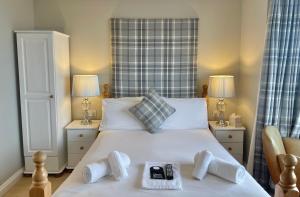 a bedroom with a large white bed with two lamps at The Seacliffe - Whitby in Whitby
