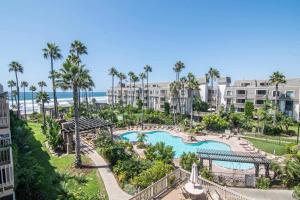 an aerial view of a resort with a pool and palm trees at Walk to the Beach Balcony Sunset Ocean Views in Oceanside +55 photos
