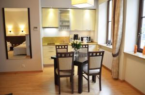 een keuken en eetkamer met een tafel en stoelen bij Apartament Dominikański in Gdańsk