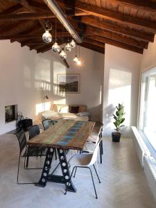 a dining room with a wooden table and chairs at NEW Lake bungalow with fireplace and hot tub in Krefeld