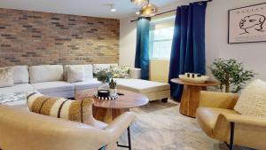 a living room with a couch and chairs and a table at Casa East Side Hotel Queen East Leslieville Suite in Toronto +17 photos