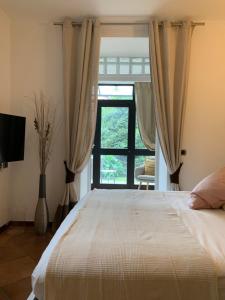 a bedroom with a large bed and a window at La Villa Como in Como +83 photos