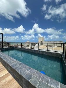 a swimming pool on the roof of a building at Bessa Flat Conforto à 180m do Mar - Storey Luxor in João Pessoa