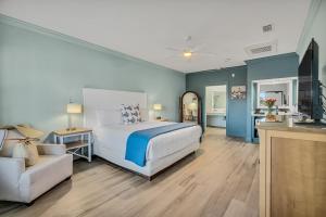 a bedroom with a bed and a chair in a room at Beachside Inn in Destin