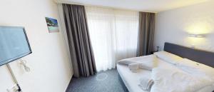 Rúm í herbergi á Boutique Hotel & Restaurant Bären Ringgenberg