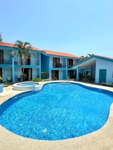a large blue pool in front of a building at Coco Maya 2b2b Villa in Coco