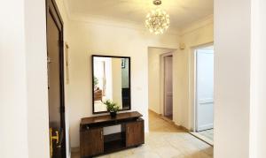 a hallway with a mirror and a dresser at Madinaty apartment 2 شقة فندقية مفروشة سوبر لوكس في مدينتي in Madinaty