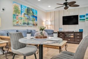 a living room with a table and chairs and a couch at Beachside Inn in Destin