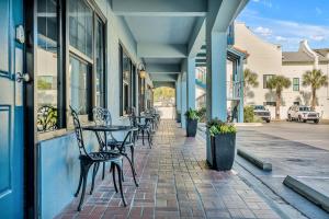 a patio with tables and chairs on a building at Beachside Inn in Destin
