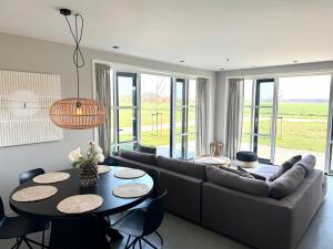 a living room with a couch and a table at Vrijvakantiehuis Brouwerijweg 45a in Domburg