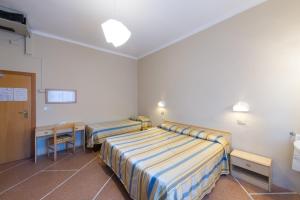 Postel nebo postele na pokoji v ubytování Hotel Moderno
