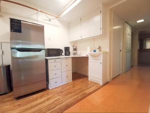 a kitchen with a stainless steel refrigerator and white cabinets at City Oasis in Issaquah