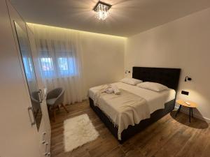 a bedroom with a bed and a chandelier at Apartments Lux Mare spectacular sea view, only a 10 meters from the beach in Podstrana