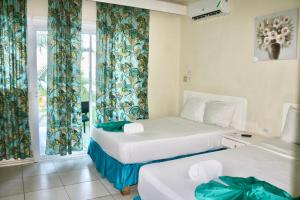 Voodi või voodid majutusasutuse Ocean Palms toas