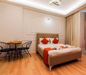 a bedroom with a bed and a table and chairs at St Basil Rooms in Istanbul