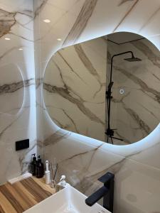 a bathroom with a sink and a mirror at Торайгырова 89 in Pavlodar