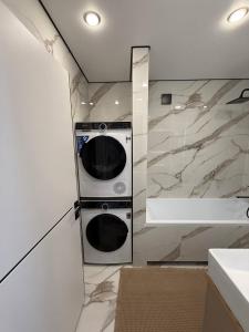 a kitchen with a washer and dryer in a wall at Торайгырова 89 in Pavlodar