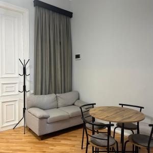 a living room with a couch and a table at Kutaisi Central Square in Kutaisi +7 photos