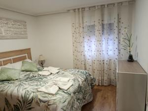 a bedroom with a bed with towels on it at San Andres 14 in Teruel