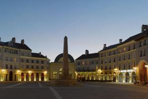 a square with a statue in front of buildings at Cosy Disney Studio - Princess & Marvel World - 6 min to Disneyland Paris in Serris