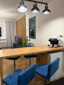 a conference room with blue chairs and a wooden table at Tabago Studio 22 Nysa, Rynek in Nysa