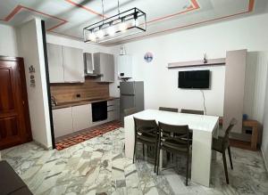 a kitchen with a table and chairs in a room at I Portici in Chiavari