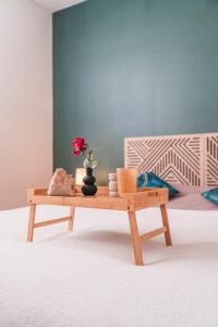 a wooden coffee table with a vase with a flower on it at La Suite 112 - Large apartment - Garden Terrace in Dachstein