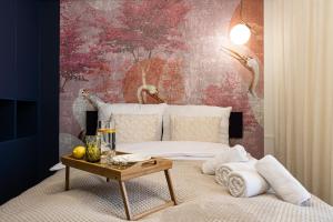 a bedroom with a bed and a table with towels at 2HomeRent Apartamenty Garbary 5 in Bydgoszcz