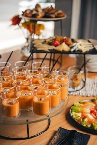 a table with glasses of food and plates of food at Crowne Plaza Madrid - Centre Retiro by IHG in Madrid +69 photos
