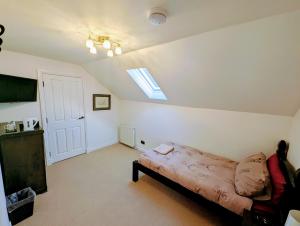 a living room with a couch and a skylight at Appin House B&B in Fort Augustus