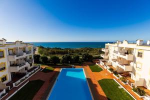 an aerial view of two apartment buildings and a swimming pool at Apartamento Amara in Carvoeira