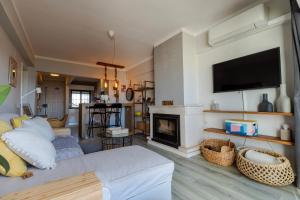a living room with a bed and a fireplace at Apartamento Amara in Carvoeira