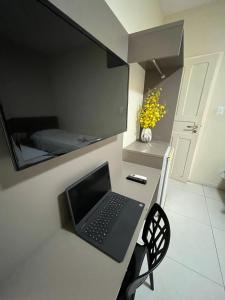 a laptop computer sitting on a desk in a room at Grace Palace Hotel in Sobral +40 photos