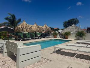 una piscina con sedie e ombrelloni accanto al resort di 4BlessingsCuracao1 a Willemstad