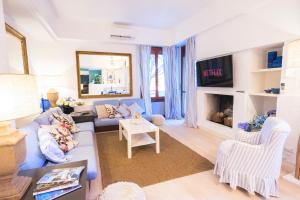 a living room with a blue couch and a tv at milano marittima luxury penthouse in Milano Marittima