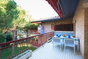 a patio with a table and chairs on a balcony at milano marittima luxury penthouse in Milano Marittima