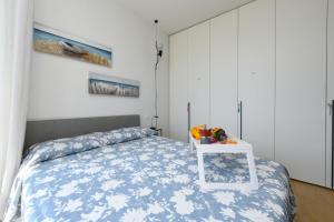 a bedroom with a bed with a table on it at Openspace Sunrise lake view in Salò