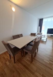 a white dining room with a table and chairs at Two storey apart Most beautiful location in Copenhagen in Copenhagen +31 photos