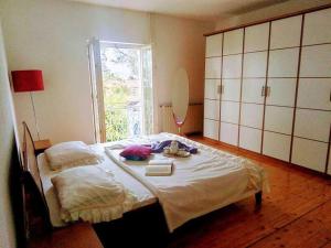 a bedroom with a large bed and a window at Apartments ROKO in Izola
