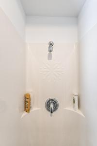 a bathroom with a sink with a faucet at Cozy Lakeside Cottage in Val des Monts