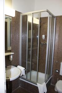a bathroom with a shower and a sink at Hotel Vier Jahreszeiten Salzburg in Salzburg