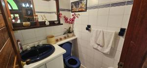 a small bathroom with a sink and a mirror at Rustic, 6BR Chalet on Beautiful Estate in Rionegro +57 photos