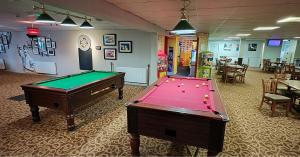 a billiard room with two pool tables in it at Whitstable Beaumont - Sleeps 6, 588 ft in Seasalter