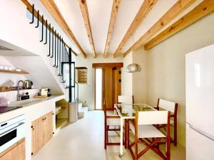 a kitchen with a glass table and chairs at MIMARE Dénia in Denia