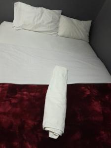 a white bed with white sheets and pillows at BDC Paarl Accommodation and Guest House in Paarl