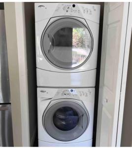 two washing machines stacked on top of each other at Gorgeous House&30 second Bus station Close C-Train& Free Parking in Calgary