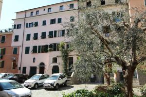 a building with cars parked in front of it at La casa del pittore con climatizzatore Pieve di Teco centro in Pieve di Teco