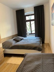a bedroom with a large bed and a window at FeWo Blick zum Lulatsch in Chemnitz